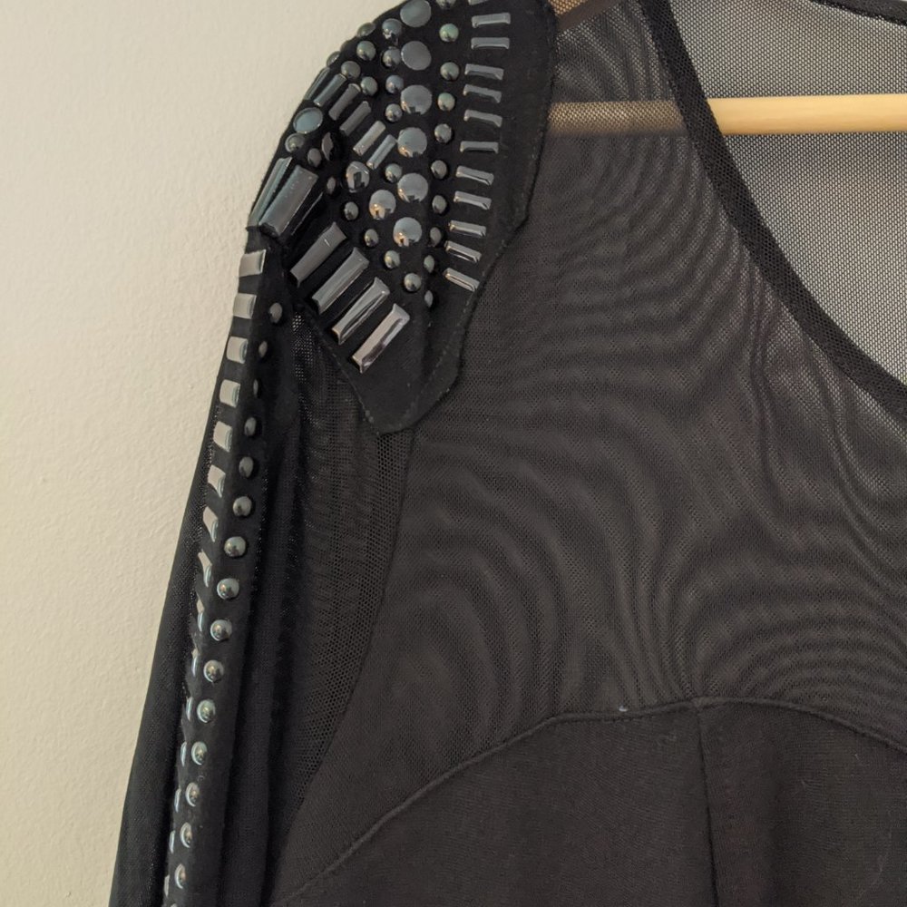 Little black dress with mesh, studded sleeve